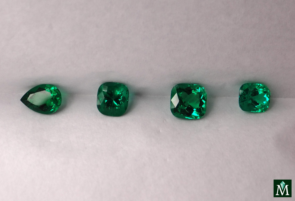 Cushion and drop parcel of emeralds